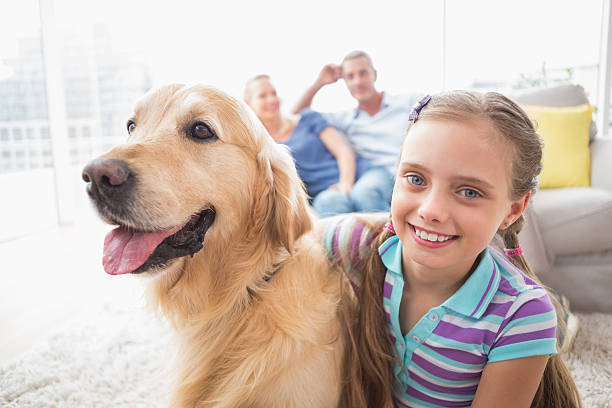 istock Girl with dog while parents relaxing at home 474509196
