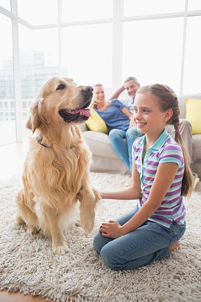 istock Girl playing with dog while parents relaxing at home 474509208