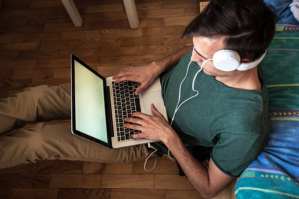 istock Young man working at his home on laptop. 474509604