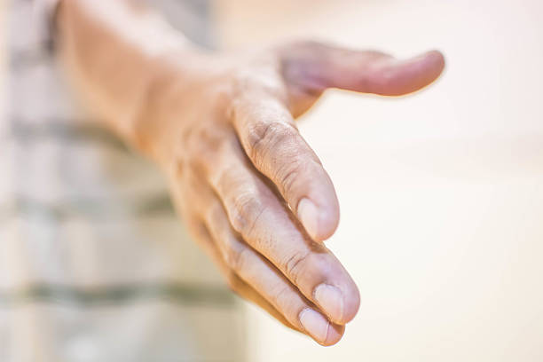 istock Asia guy extending a hand to give helps 474509874