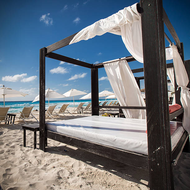 istock Luxury wooden lounge beds on caribbean beach 474512054