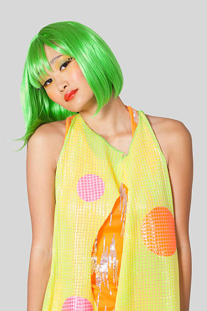 istock Funky young woman with green hair standing 474514113