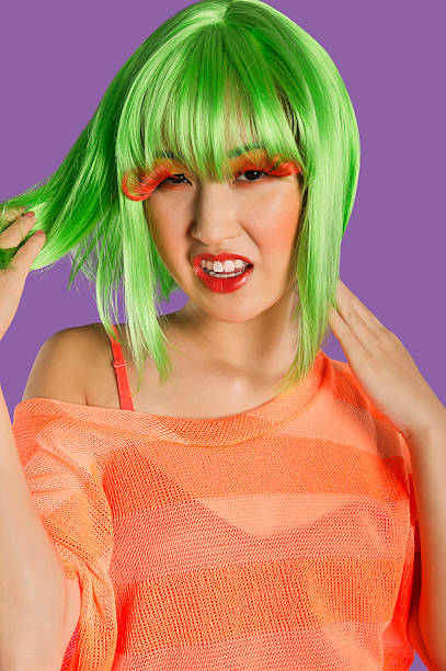 istock Irritated young funky woman standing over purple background 474514167