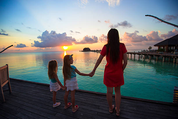 istock Young mother and two her kids at exotic resort 474517046
