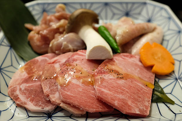 istock Raw fresh meat on plate board with vegetable background 474517354