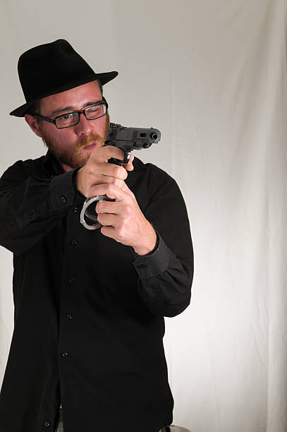 istock Man Holding a Pistol Gun 474518313