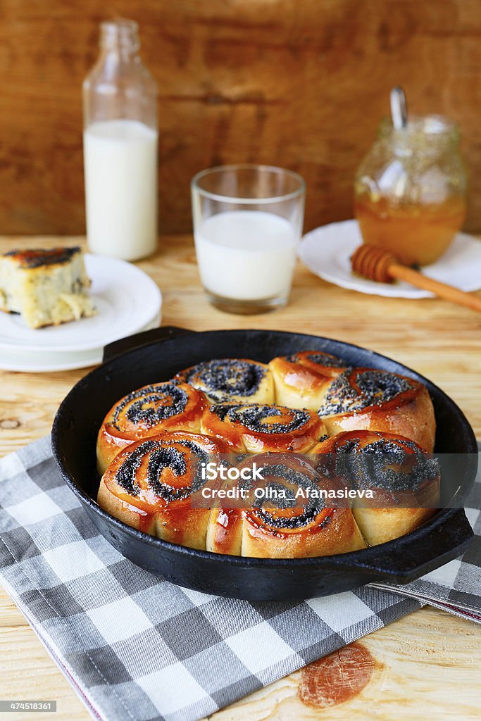 buns with poppy seeds and honey buns with poppy seeds and honey, food closeup Baked Stock Photo