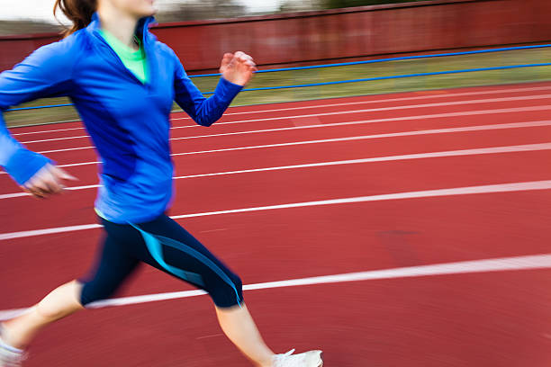 istock Young woman running at a track and field stadium 474518863