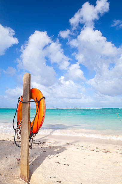 istock Red life buoy hanging on wooden pole 474520174