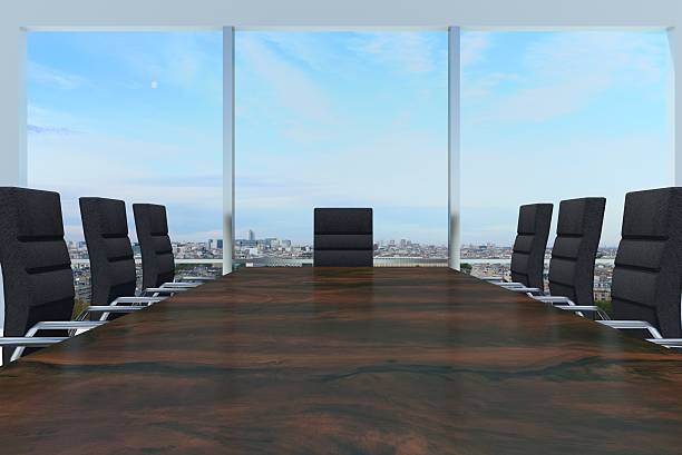 conference room with large wooden desk and skyline window large conference room with large wooden desk and skyline window chairperson stock pictures, royalty-free photos & images