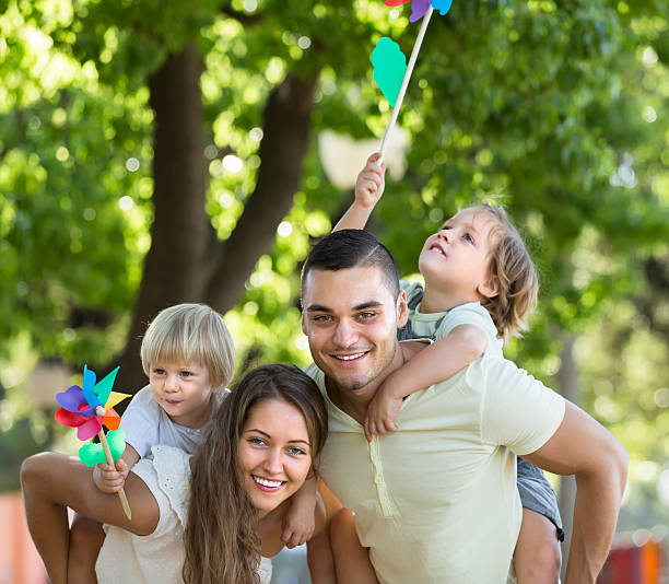 istock Family with toy windmills at park 474520872