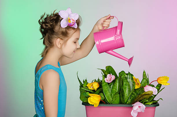 istock girl watering  beautiful flowers 474521312