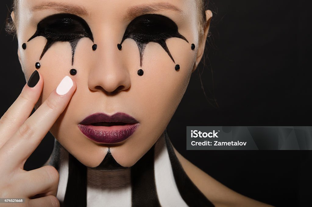 portrait with creative black and white makeup Woman portrait with creative black and white makeup on dark background 20-29 Years Stock Photo