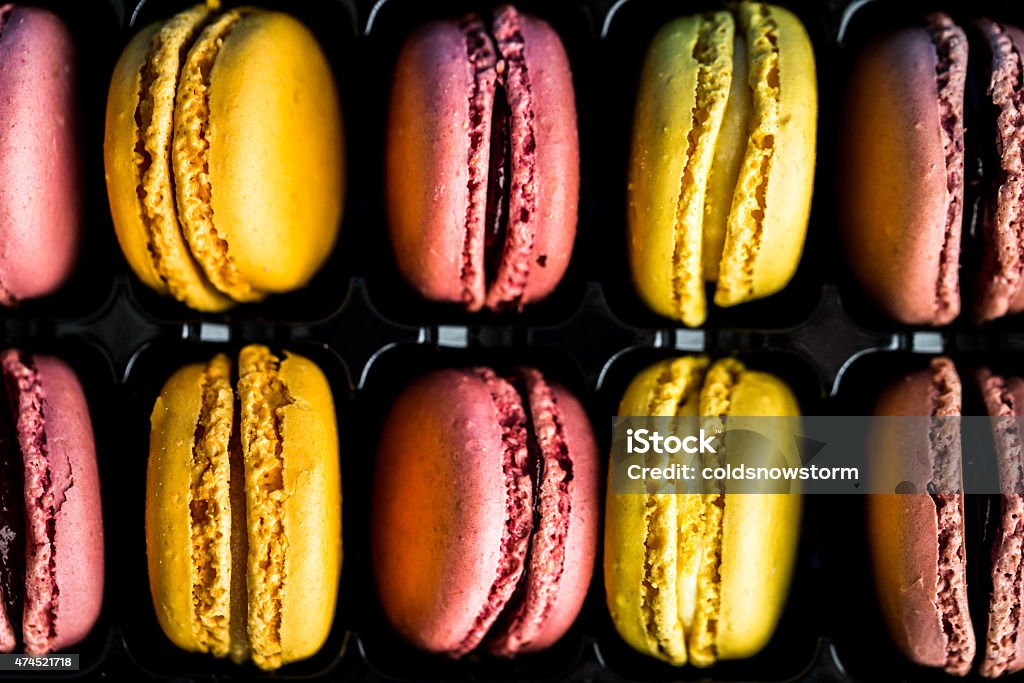 Brightly coloured macaroons in a row Macro abstract shot of brightly coloured macaroons in a row. Horizontal colour image processed from an original RAW file for maximum quality. 2015 Stock Photo