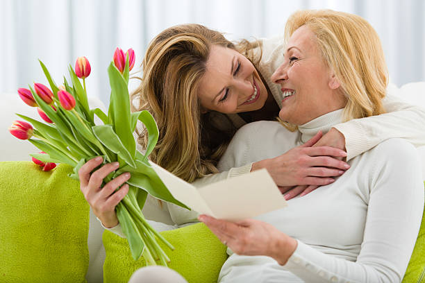 madre riceve tulipani e carta figlia saluto - mothers day mother single flower family foto e immagini stock