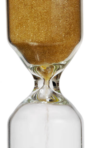 istock golden sand glass isolated on white 474524401