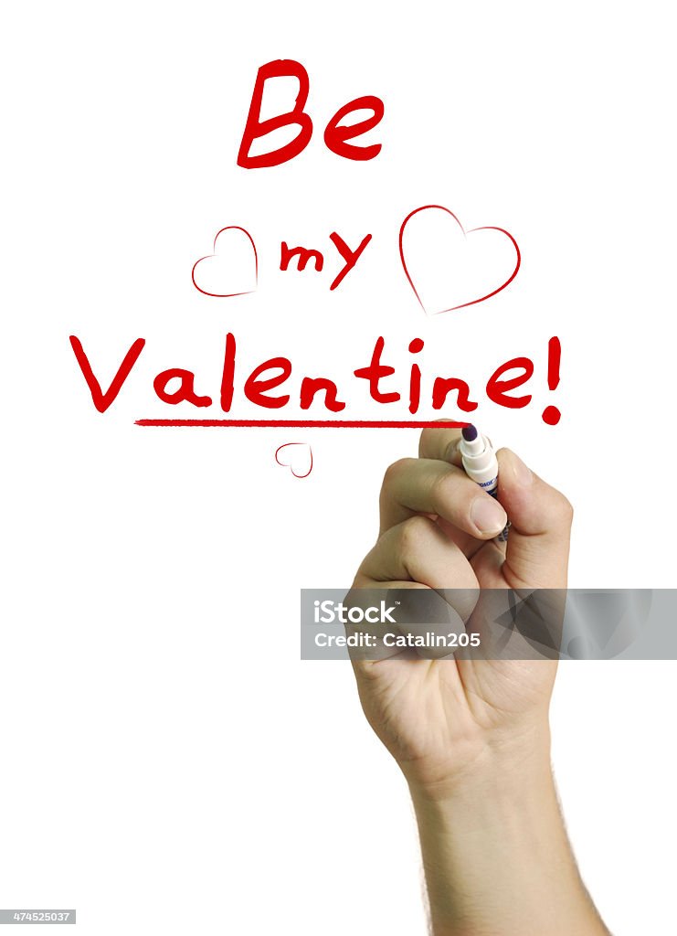 Be My Valentine I say! Male hand writing on screen Be my Valentine with a red marker on an isolated white background. Adult Stock Photo