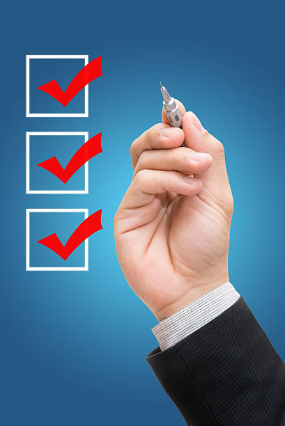 istock Businessman checking mark checklist marker Isolated 474526078