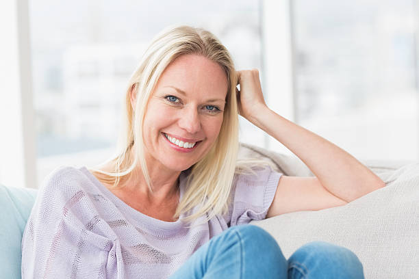 istock Woman relaxing on sofa in living room 474537172