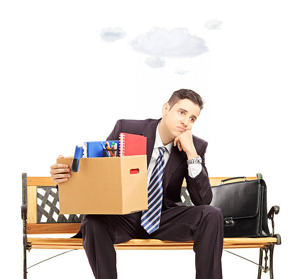 istock Sad young businessman with cloud over head holding box 474537745