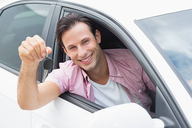 istock Man smiling and holding key 474538058