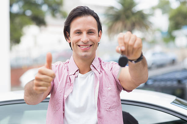 istock Man smiling and showing thumbs up 474540242