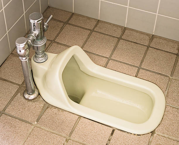 Squat toilet A public squat toilet in Asia. japanese toilet stock pictures, royalty-free photos & images
