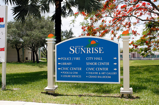 Sunrise, FL, USA - June 19, 2014: Large entrance sign that gives points with arrows to the various government agencies and building located in the area. 