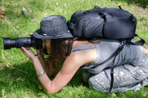 Toronto, Canada - June 17, 2012: Female Aspiring Photographer Taking a Shot with Her Camera at Midday in Summer