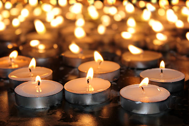 burning memorial candles burning memorial candles on dark background holocaust stock pictures, royalty-free photos & images