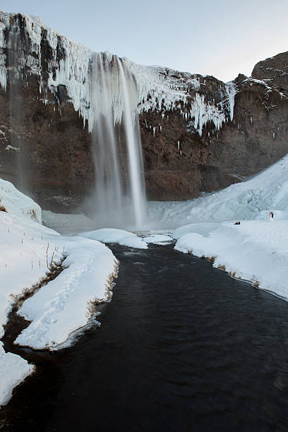 istock Seljalandfoss falling among the ice and snow. 474549620