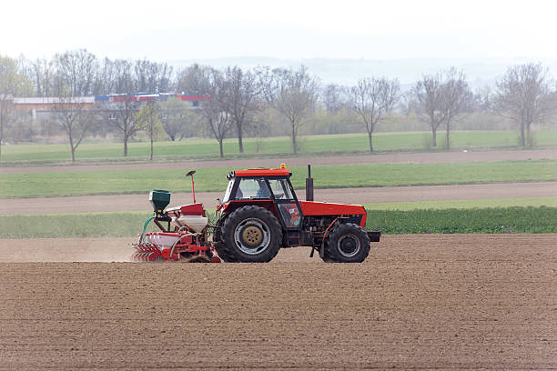 istock Tractor harrowing the field 474550636