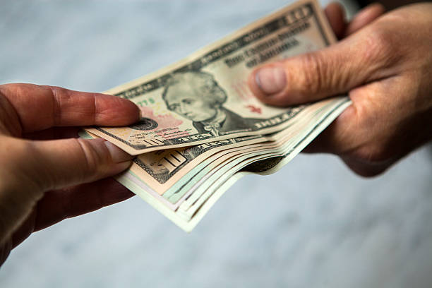 istock Hands giving and receiving money 474551628