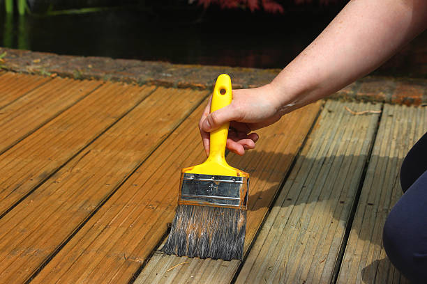 istock Image of garden decking being painted / stained, wood preserver varnish 474551732