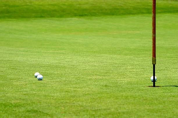 istock Golf balls near flagstick 474552032