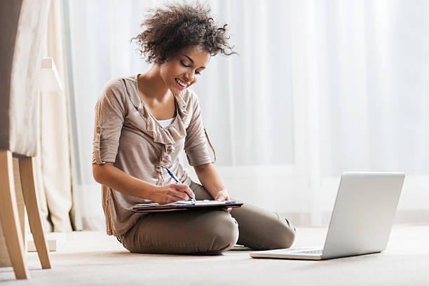 istock Smiling African American female student studying at home. 474552138