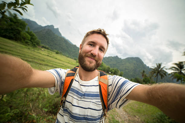 istock Cheerful man on hiking trip taking a selfie 474552452
