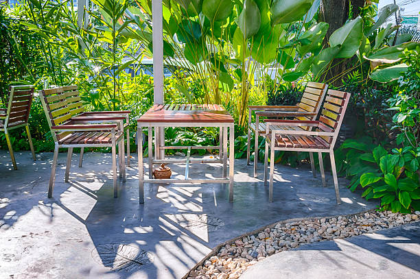 istock Wooden table set in lush garden setting 474552842