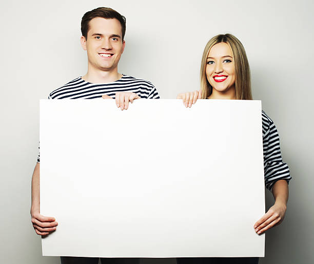 istock Couple holding a banner 474553040
