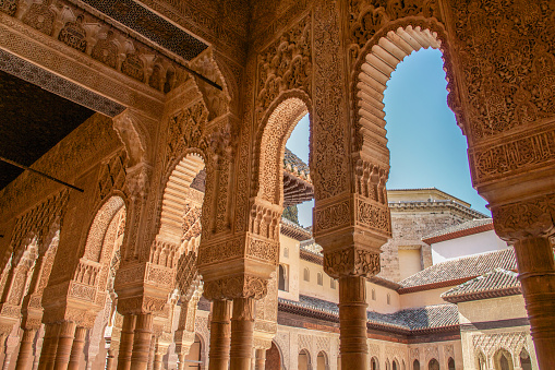 Granada, Spain - March 7, 2014: The Alhambra columns around the Court of the Lions in sunny morning.