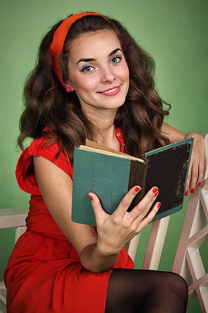 istock Girl in retro style with emotions reading a book 474558691