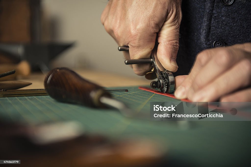 Artisan working with leather Close up shoot of an artisan working with leather in his laboratory. 30-39 Years Stock Photo