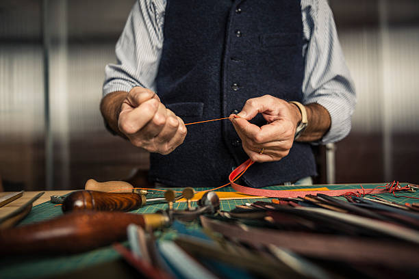 Artisan working with leather stock photo