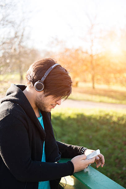 istock Young happy man with ear phone 474564461