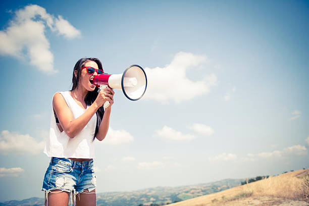 Young woman with megaphone stock photo