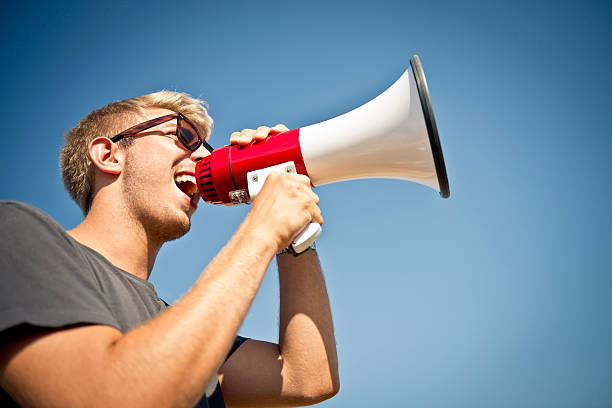 Young man with megaphone stock photo