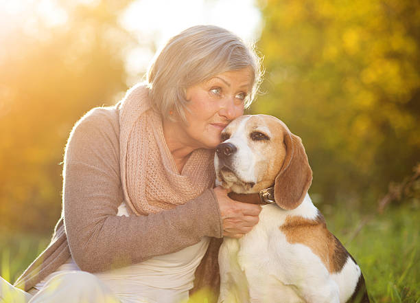 istock Active senior woman hugs dog 474567499