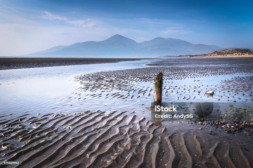 Stranded This is the scene as you walk along the beach at the Murlough Nature Reserve near the town of Newcastle, County Down.  The backdrop are the stunning Mourne Mountains that include the highest peak, Slieve Donard which stands at 849m.  The view is the one that many of the worlds leading golfers will have during this years 2015 Irish Open being played at Royal County Down. Mourne Mountains Stock Photo