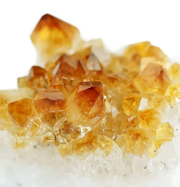 Several crystals of citrine gemstone on white background