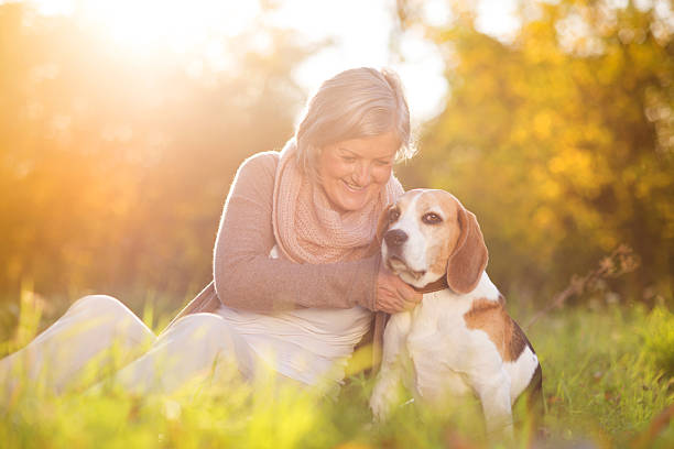 istock Active senior woman hugs dog 474572219